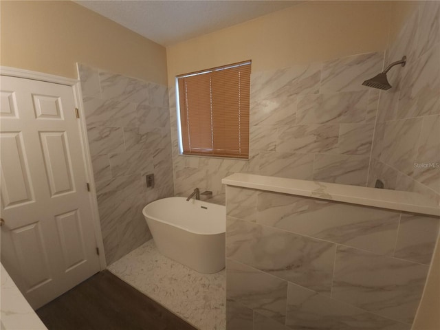222 Bacopa Pass, Davenport, FL 33897 - full bathroom featuring a freestanding tub, tiled shower, and tile walls