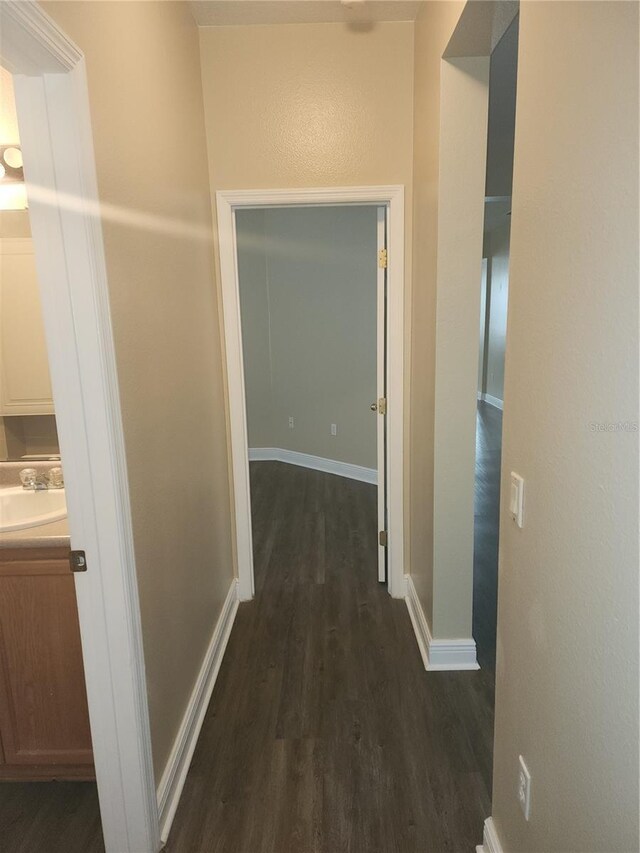222 Bacopa Pass, Davenport, FL 33897 - corridor featuring dark wood finished floors and baseboards