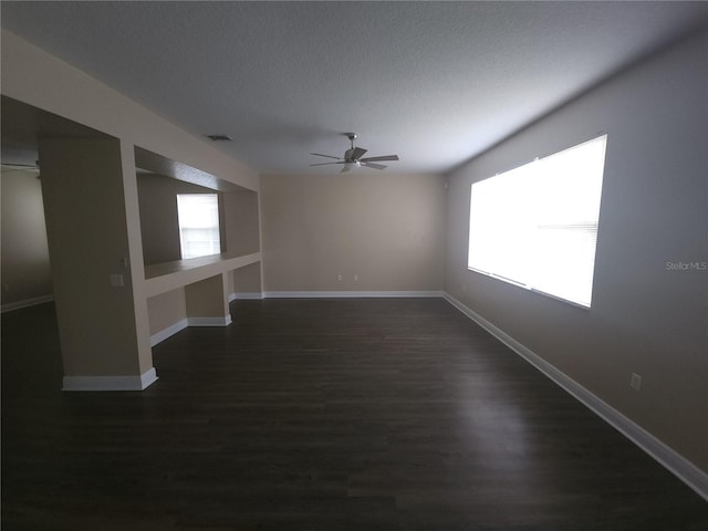 222 Bacopa Pass, Davenport, FL 33897 - spare room with ceiling fan, dark wood-type flooring, and a textured ceiling