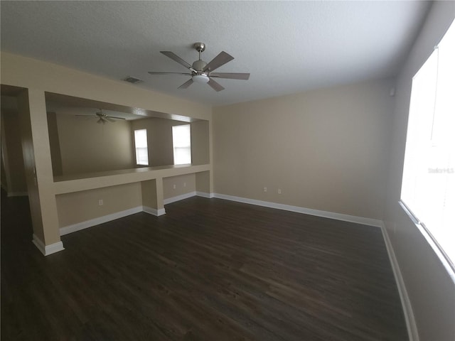 222 Bacopa Pass, Davenport, FL 33897 - empty room featuring ceiling fan, plenty of natural light, dark wood-type flooring, and a textured ceiling