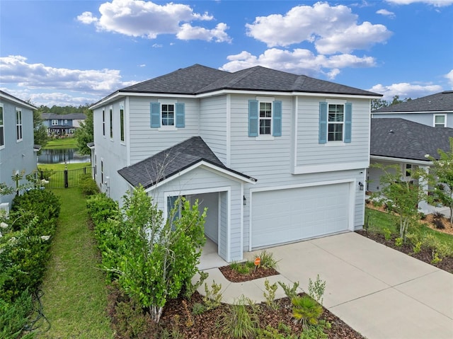 562 Meadow Ridge Dr, Saint Augustine, FL 32092 - traditional-style home featuring a garage, a shingled roof, concrete driveway, and a water view