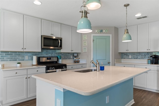 562 Meadow Ridge Dr, Saint Augustine, FL 32092 - kitchen with stainless steel appliances, decorative backsplash, dark wood-type flooring, white cabinets, and recessed lighting