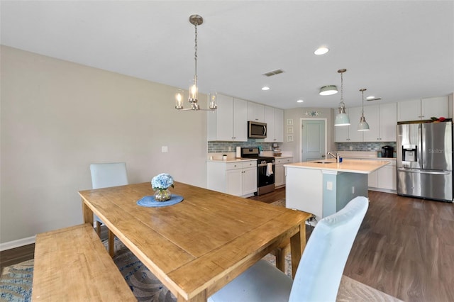 562 Meadow Ridge Dr, Saint Augustine, FL 32092 - dining space with dark wood-style floors, recessed lighting, and a chandelier