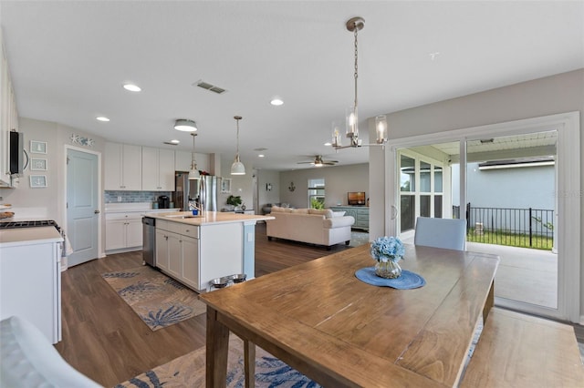 562 Meadow Ridge Dr, Saint Augustine, FL 32092 - dining area with dark wood-style flooring, ceiling fan, recessed lighting, and a chandelier