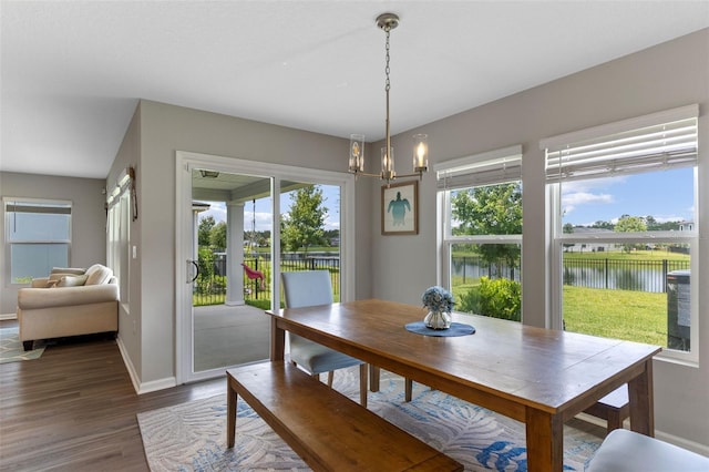 562 Meadow Ridge Dr, Saint Augustine, FL 32092 - dining space with a chandelier, wood finished floors, and a water view