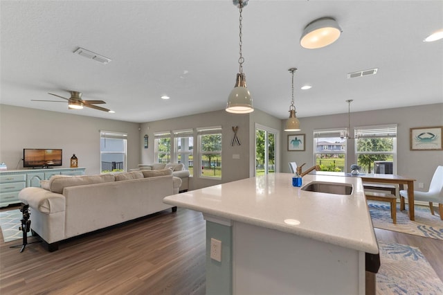 562 Meadow Ridge Dr, Saint Augustine, FL 32092 - kitchen featuring dark wood-style flooring, recessed lighting, a ceiling fan, pendant lighting, and an island with sink