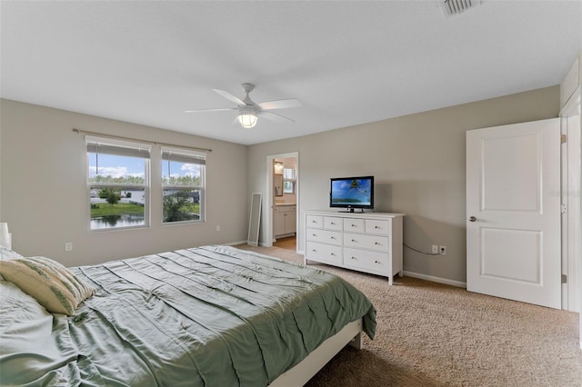 562 Meadow Ridge Dr, Saint Augustine, FL 32092 - bedroom with light carpet, a ceiling fan, and connected bathroom