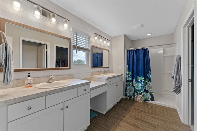 562 Meadow Ridge Dr, Saint Augustine, FL 32092 - bathroom with vanity, curtained shower, wood finished floors, and a spacious closet