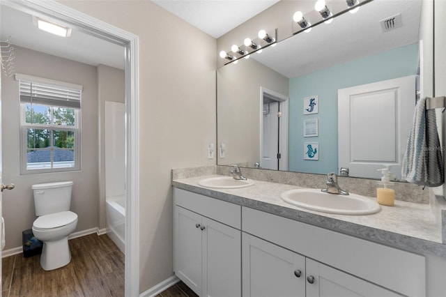 562 Meadow Ridge Dr, Saint Augustine, FL 32092 - full bathroom with double vanity, wood finished floors, and bathtub / shower combination
