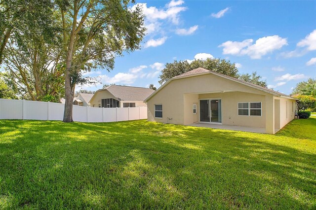 33234 Kaylee Way, Leesburg, FL 34788 - back of house with a patio and stucco siding