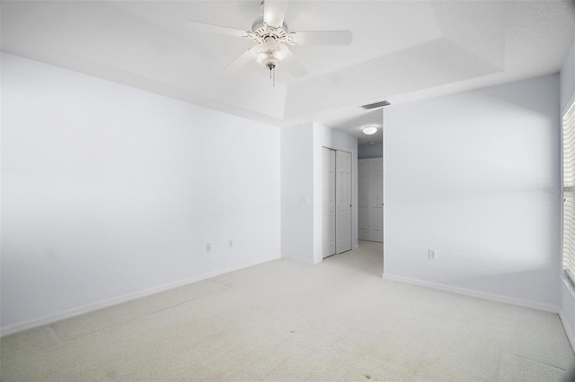 33234 Kaylee Way, Leesburg, FL 34788 - unfurnished bedroom with carpet flooring, a raised ceiling, and ceiling fan