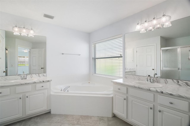 33234 Kaylee Way, Leesburg, FL 34788 - full bath with two vanities, a stall shower, and a garden tub