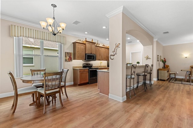 4210 Arlington Ridge Blvd, Leesburg, FL 34748 - dining area with crown molding, arched walkways, a chandelier, light wood-style flooring, and recessed lighting
