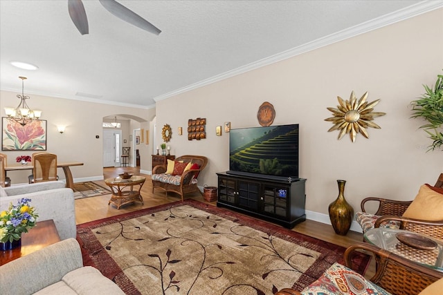 4210 Arlington Ridge Blvd, Leesburg, FL 34748 - living area featuring arched walkways, wood finished floors, ornamental molding, ceiling fan, and a chandelier