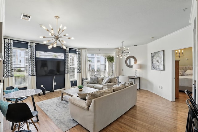 2639 Maitland Crossing Way Unit 102, Orlando, FL 32810 - living room featuring a chandelier, plenty of natural light, light wood-type flooring, and crown molding