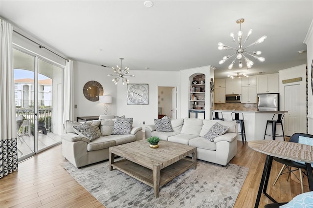 2639 Maitland Crossing Way Unit 102, Orlando, FL 32810 - living area featuring a chandelier and light wood-style floors