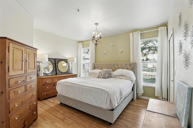 2639 Maitland Crossing Way Unit 102, Orlando, FL 32810 - bedroom featuring light wood-style flooring and a chandelier