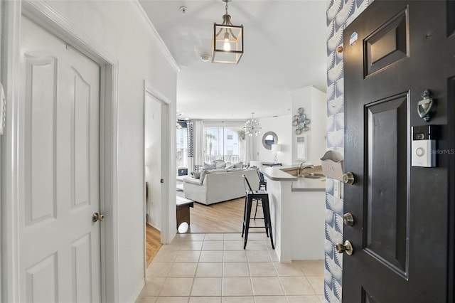 2639 Maitland Crossing Way Unit 102, Orlando, FL 32810 - foyer featuring light tile patterned floors and a chandelier