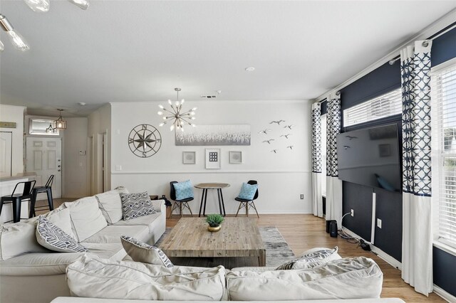 2639 Maitland Crossing Way Unit 102, Orlando, FL 32810 - living area featuring a chandelier and light wood-type flooring