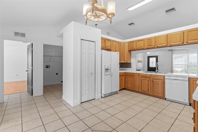 204 Lori Ct, Umatilla, FL 32784 - kitchen featuring white appliances, vaulted ceiling, light tile patterned floors, a chandelier, and pendant lighting
