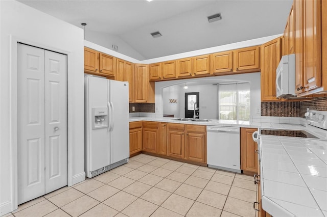 204 Lori Ct, Umatilla, FL 32784 - kitchen featuring white appliances, tile countertops, lofted ceiling, backsplash, and light tile patterned floors