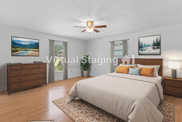 204 Lori Ct, Umatilla, FL 32784 - bedroom featuring multiple windows, light wood-style floors, a textured ceiling, and a ceiling fan