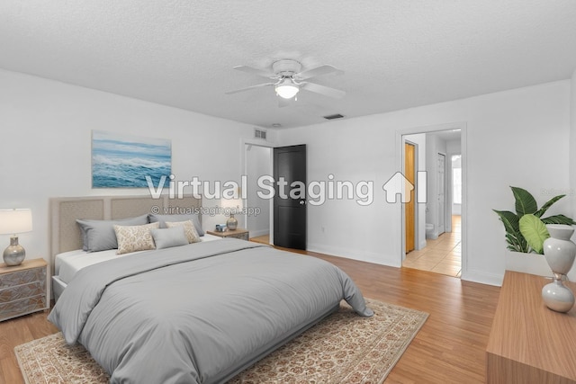 204 Lori Ct, Umatilla, FL 32784 - bedroom with light wood-type flooring, a textured ceiling, and ceiling fan