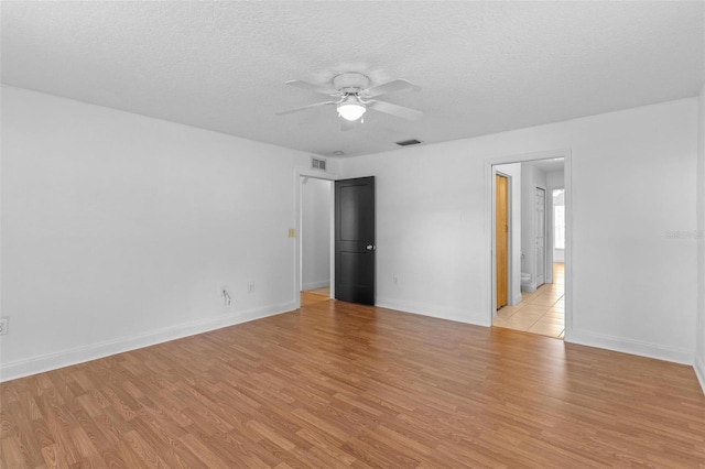 204 Lori Ct, Umatilla, FL 32784 - empty room featuring a ceiling fan, light wood-style flooring, and a textured ceiling