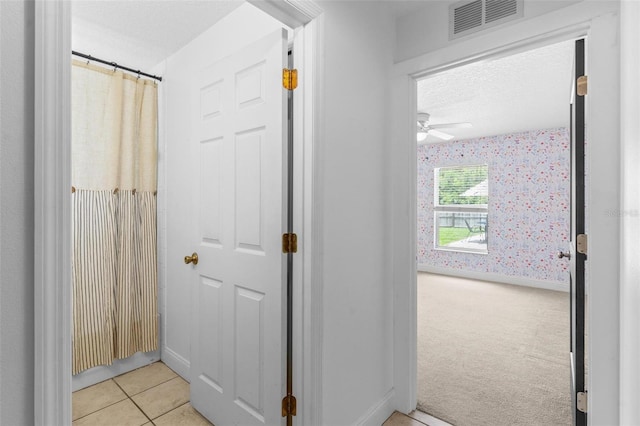 204 Lori Ct, Umatilla, FL 32784 - hallway featuring wallpapered walls, light tile patterned flooring, and light colored carpet