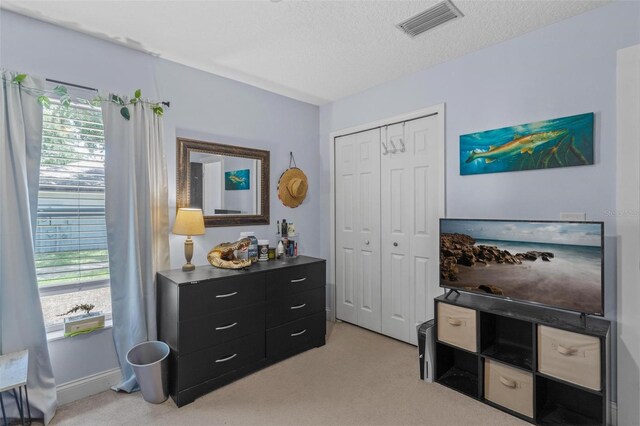 204 Lori Ct, Umatilla, FL 32784 - bedroom featuring light carpet, a closet, and a textured ceiling