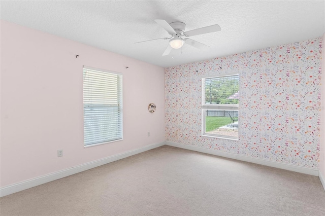 204 Lori Ct, Umatilla, FL 32784 - unfurnished room featuring light carpet, wallpapered walls, a ceiling fan, and a textured ceiling