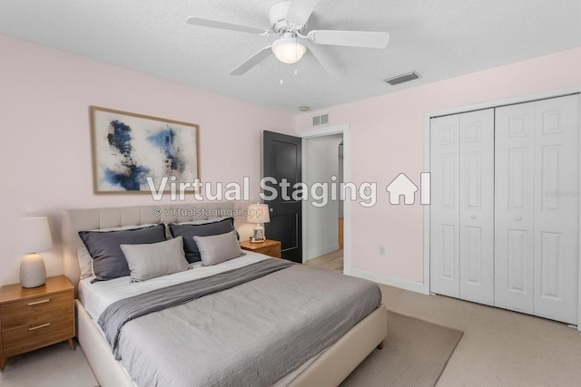 204 Lori Ct, Umatilla, FL 32784 - bedroom featuring a closet, a ceiling fan, a textured ceiling, and light colored carpet