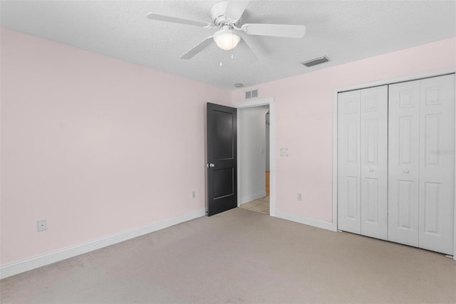 204 Lori Ct, Umatilla, FL 32784 - unfurnished bedroom with light colored carpet, a textured ceiling, a closet, and a ceiling fan