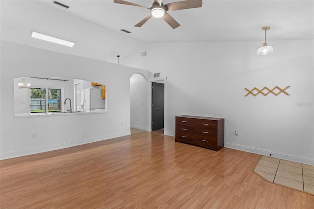 204 Lori Ct, Umatilla, FL 32784 - unfurnished room featuring vaulted ceiling, a ceiling fan, arched walkways, and light wood-type flooring