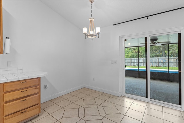 204 Lori Ct, Umatilla, FL 32784 - unfurnished dining area with a chandelier, light tile patterned floors, and ceiling fan