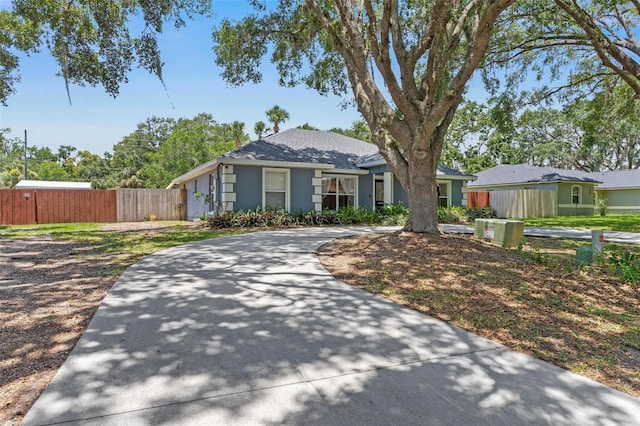 204 Lori Ct, Umatilla, FL 32784 - single story home with stucco siding, a shingled roof, and concrete driveway