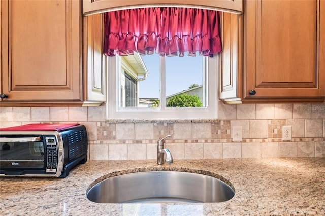 3460 Idlewood Loop, The Villages, FL 32162 - kitchen with light stone countertops and backsplash