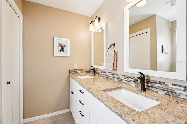 3460 Idlewood Loop, The Villages, FL 32162 - bathroom featuring double vanity, decorative backsplash, and tile patterned floors