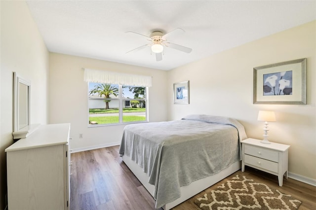 3460 Idlewood Loop, The Villages, FL 32162 - bedroom featuring dark wood finished floors and ceiling fan