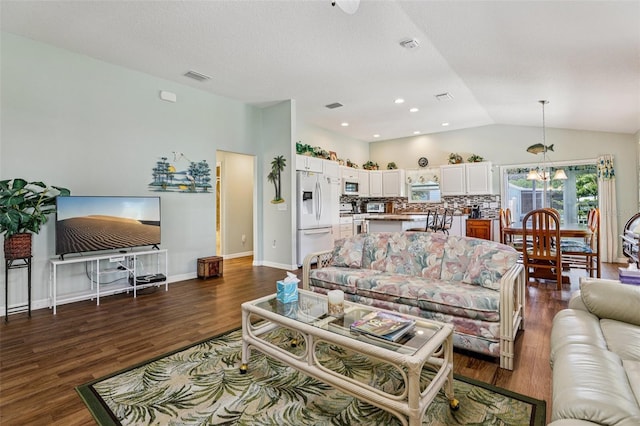 703 Royal Palm Ave, Lady Lake, FL 32159 - living area with lofted ceiling, dark wood-style floors, and a chandelier