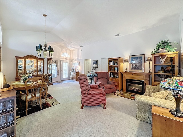 3716 Eversholt St, Clermont, FL 34711 - carpeted living room featuring a chandelier, a glass covered fireplace, and high vaulted ceiling