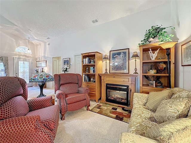 3716 Eversholt St, Clermont, FL 34711 - carpeted living room with a glass covered fireplace and a textured ceiling