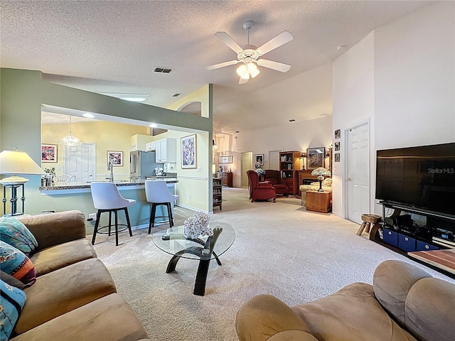 3716 Eversholt St, Clermont, FL 34711 - living room featuring light carpet, lofted ceiling, ceiling fan, and a textured ceiling