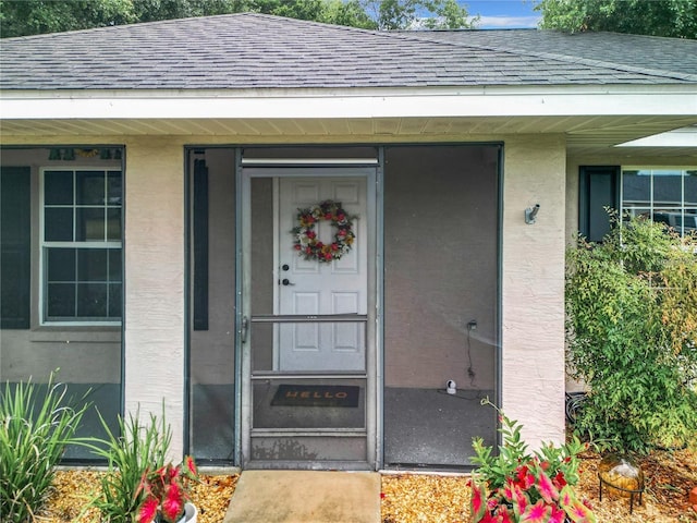 12181 SE 87th Ct, Belleview, FL 34420 - view of exterior entry with roof with shingles