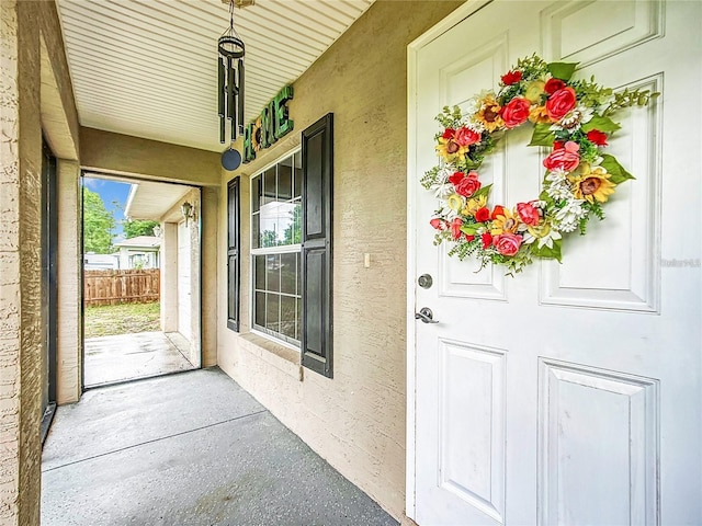 12181 SE 87th Ct, Belleview, FL 34420 - doorway to property with covered porch and stucco siding