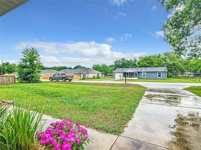 12181 SE 87th Ct, Belleview, FL 34420 - view of grassy yard featuring concrete driveway