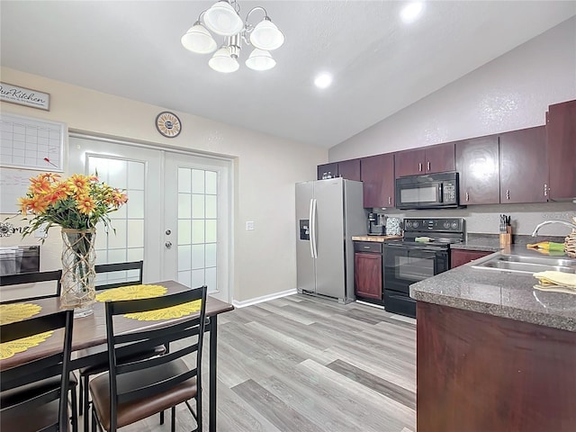 12181 SE 87th Ct, Belleview, FL 34420 - kitchen featuring black appliances, lofted ceiling, a chandelier, and light wood-style flooring