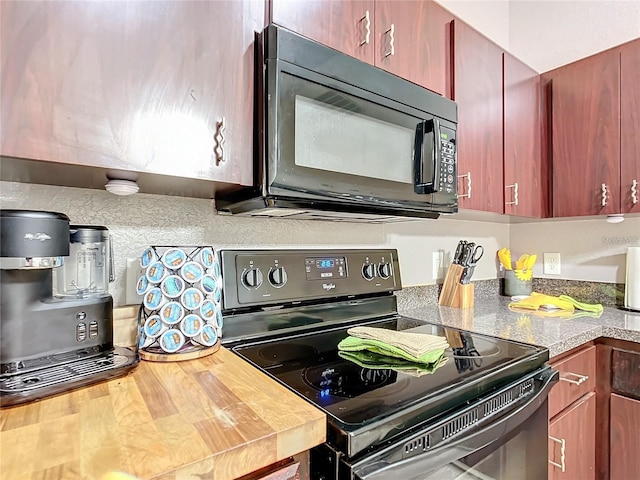 12181 SE 87th Ct, Belleview, FL 34420 - kitchen with black appliances and wooden counters