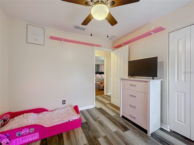 12181 SE 87th Ct, Belleview, FL 34420 - bedroom with wood finished floors and a ceiling fan