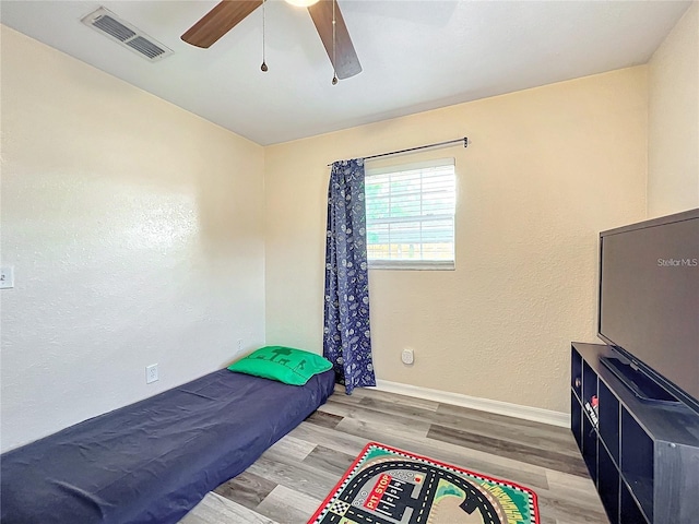 12181 SE 87th Ct, Belleview, FL 34420 - bedroom featuring wood finished floors and a ceiling fan